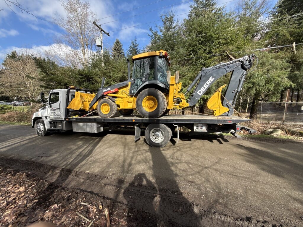 Sell construction equipment for cash - John Deere backhoe loader loaded for pickup in Mission